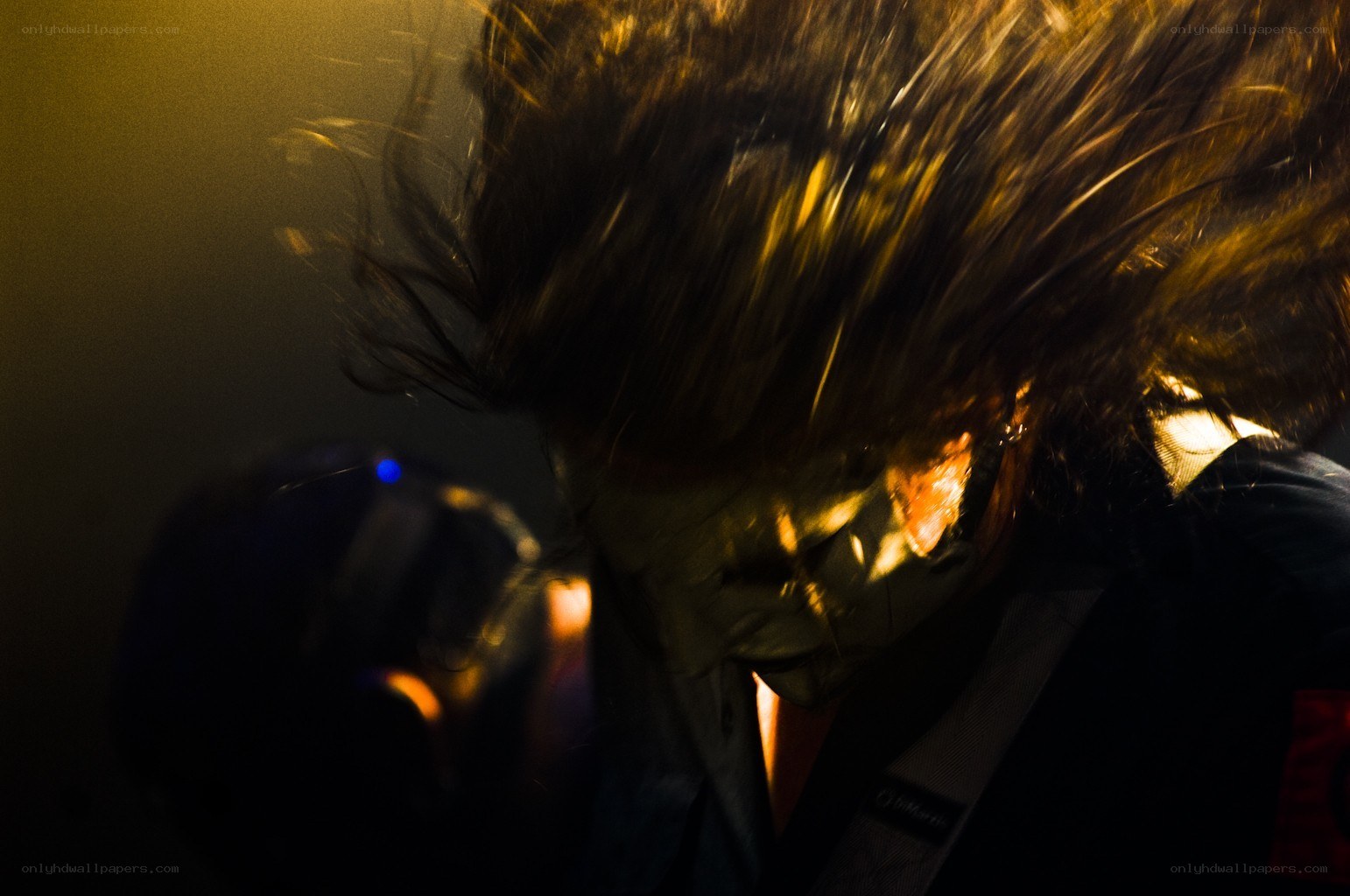 Musician headbanging on stage
