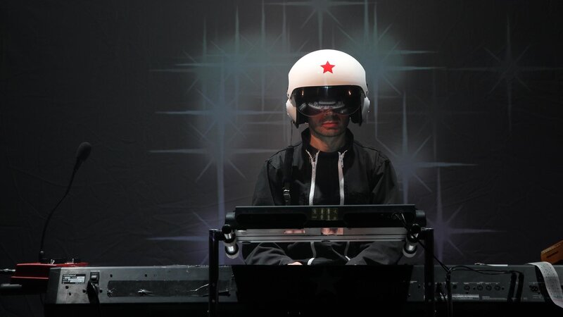 musician in helmet at keyboard