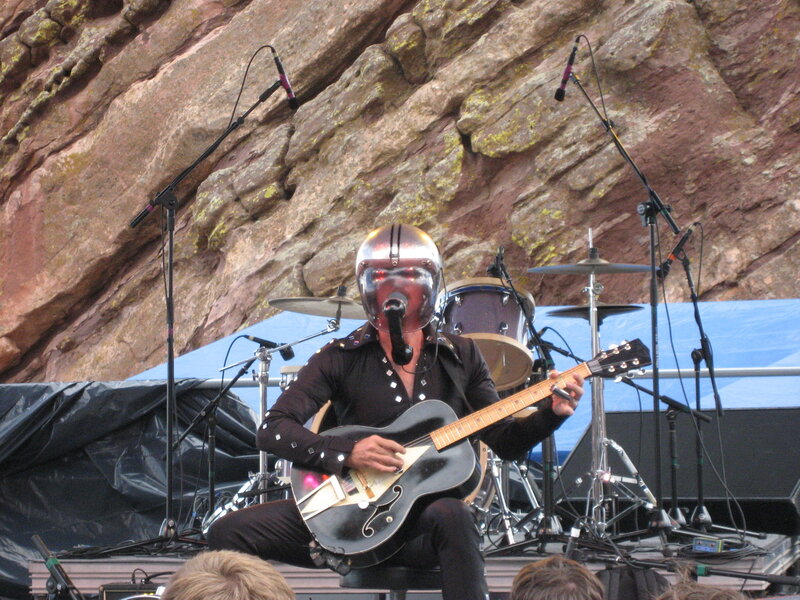 Musician in helmet playing guitar