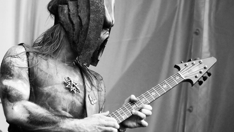 musician in mask playing guitar