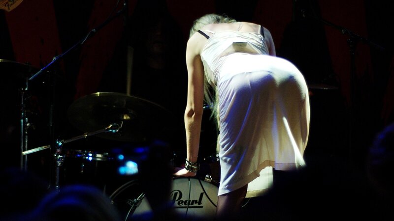 Musician on stage in white dress