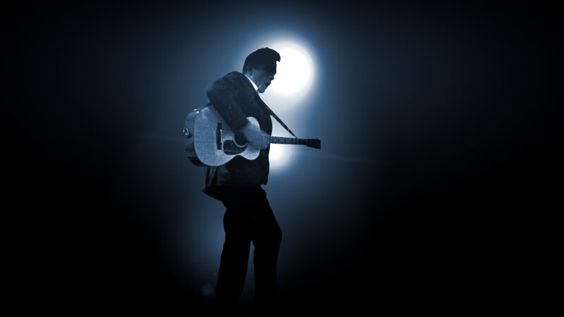 musician on stage with guitar