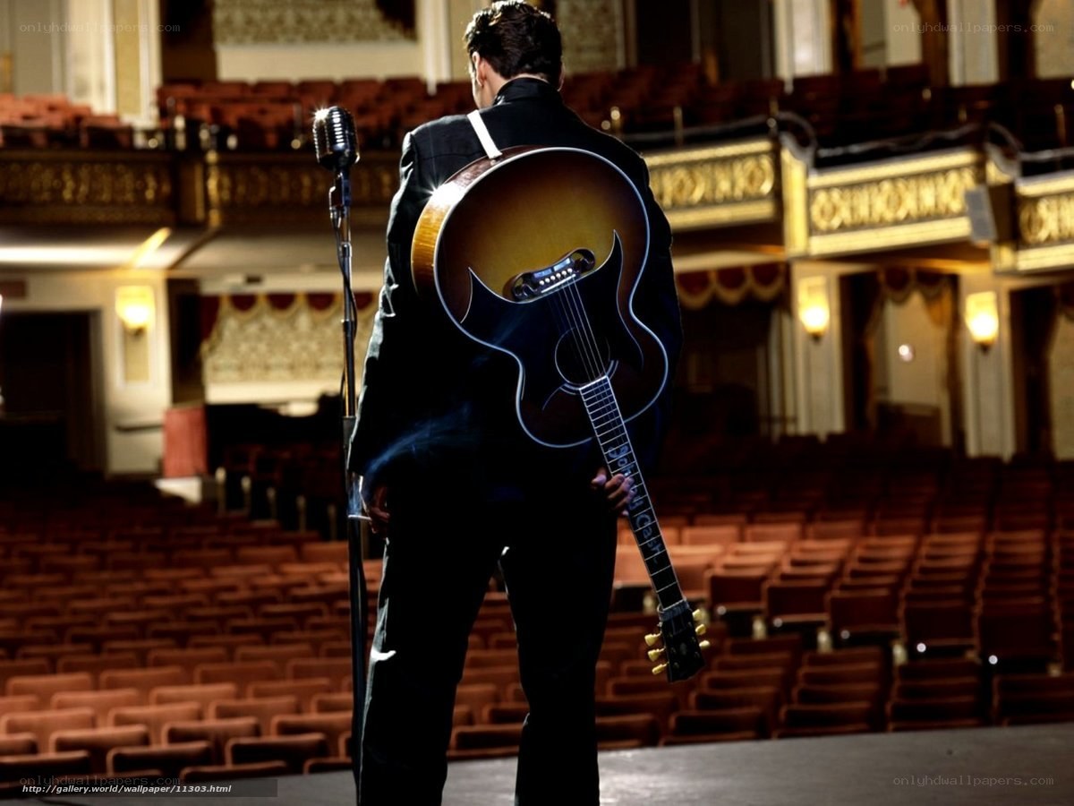 Musician on stage with guitar
