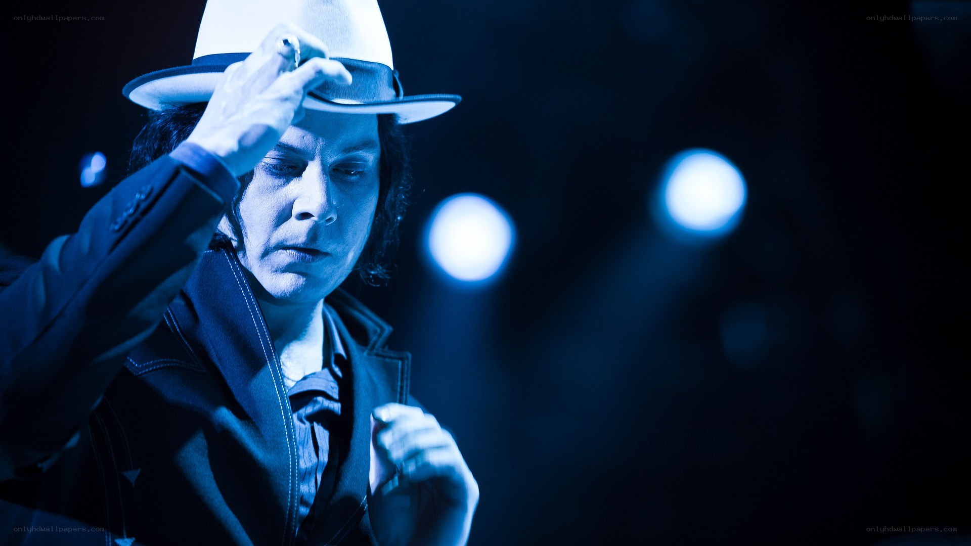 musician on stage with hat