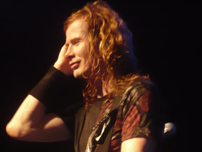musician on stage with long hair