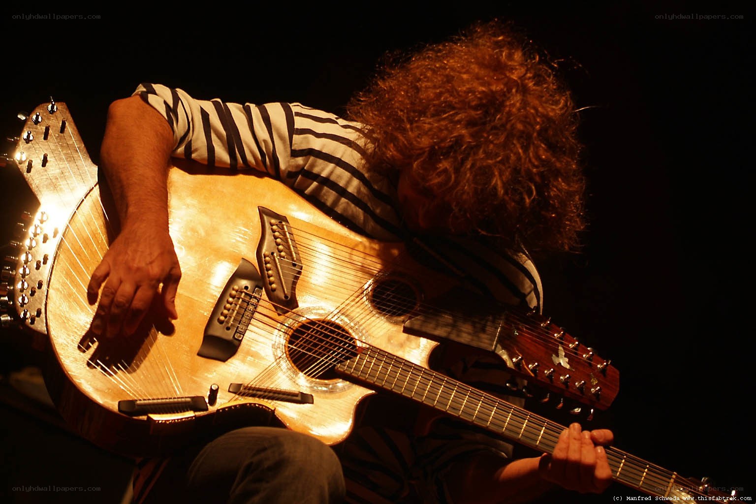 Musician playing a unique guitar