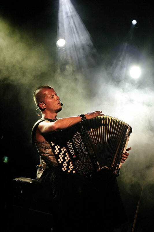 Musician playing accordion on stage