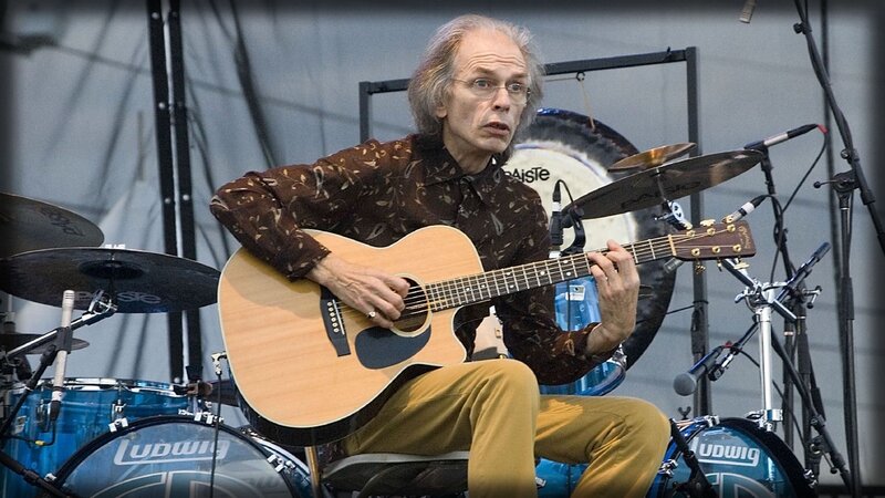 musician playing acoustic guitar