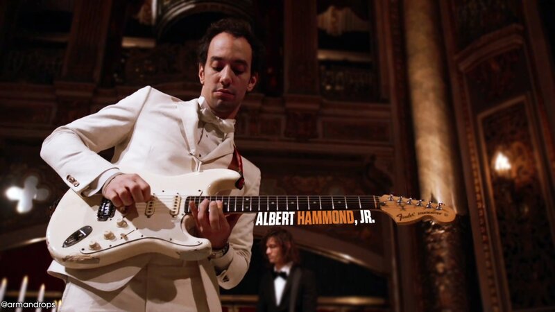 Musician playing guitar in a theater