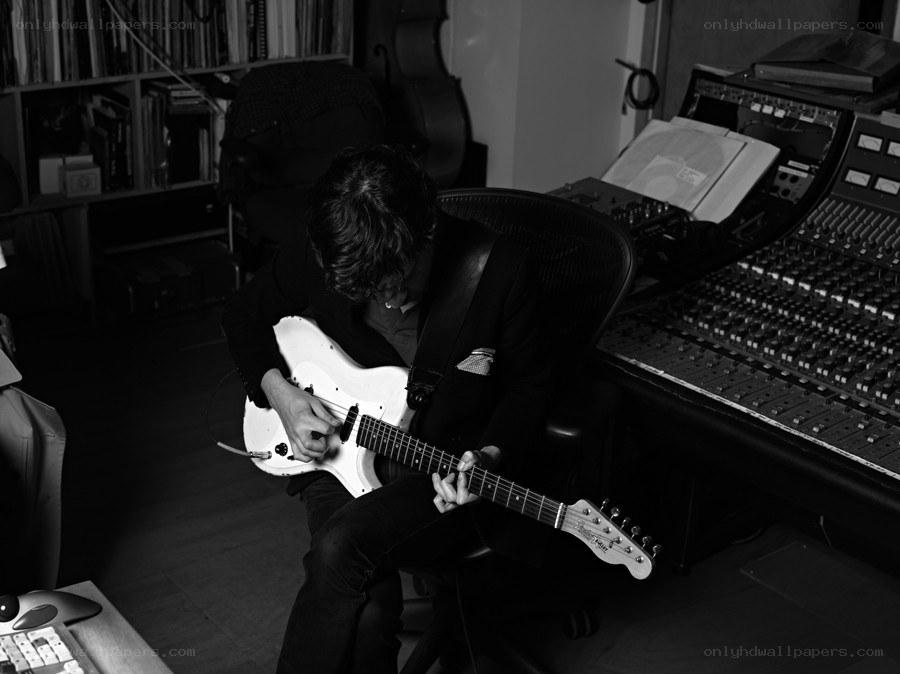 Musician playing guitar in studio