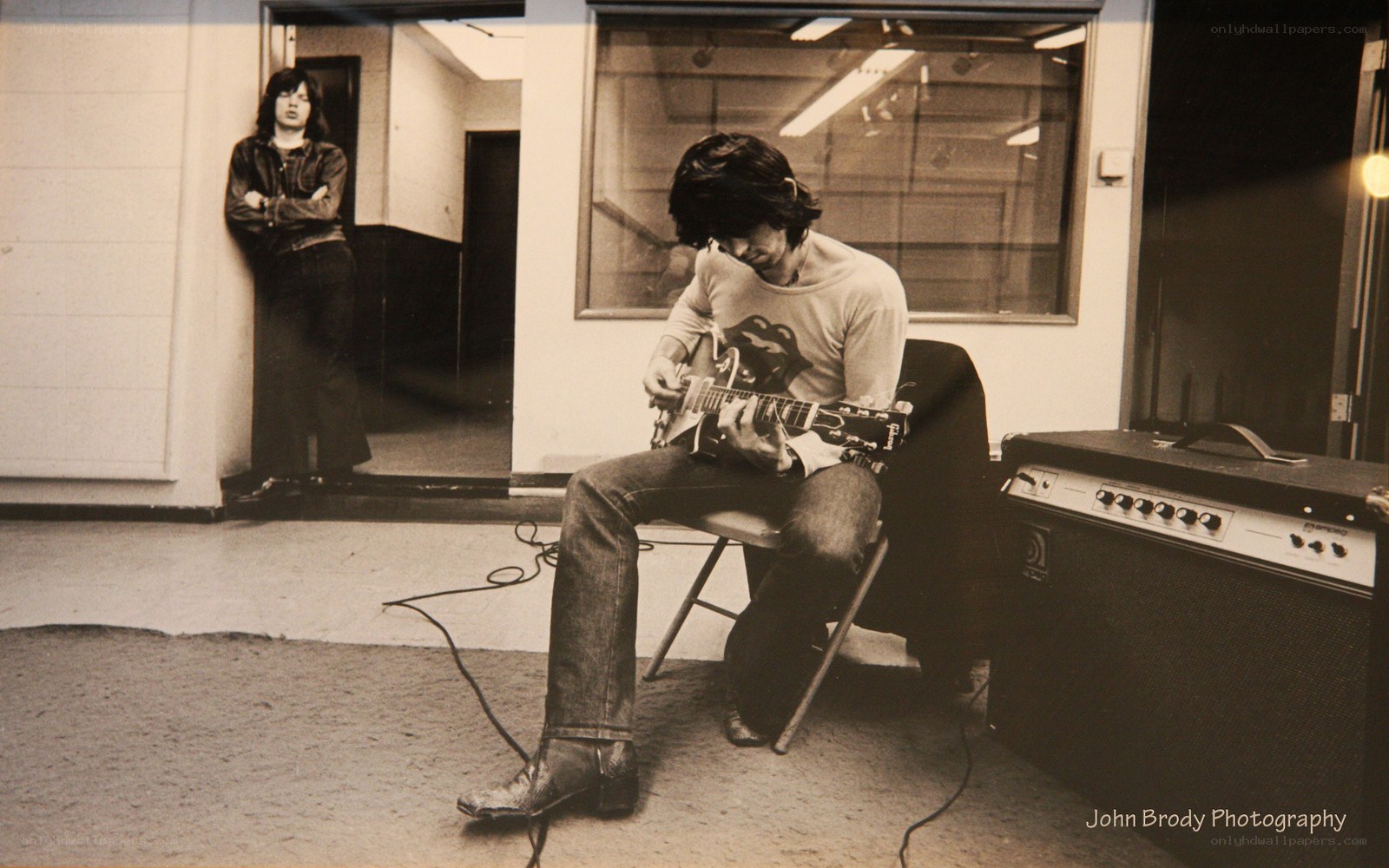 Musician playing guitar in studio