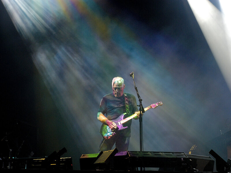 Musician playing guitar on stage