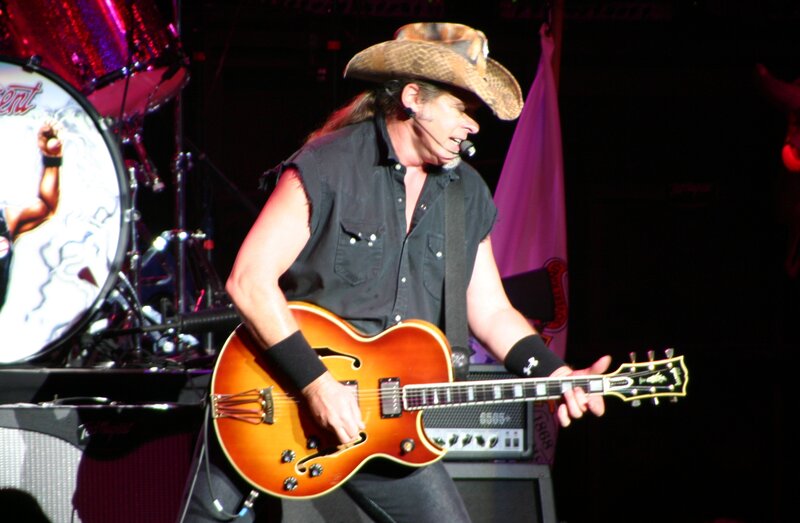 Musician playing guitar on stage