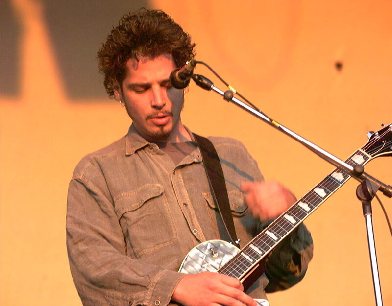 musician playing guitar on stage