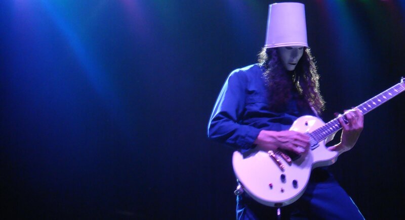 Musician playing guitar on stage