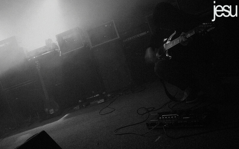Musician playing guitar on stage