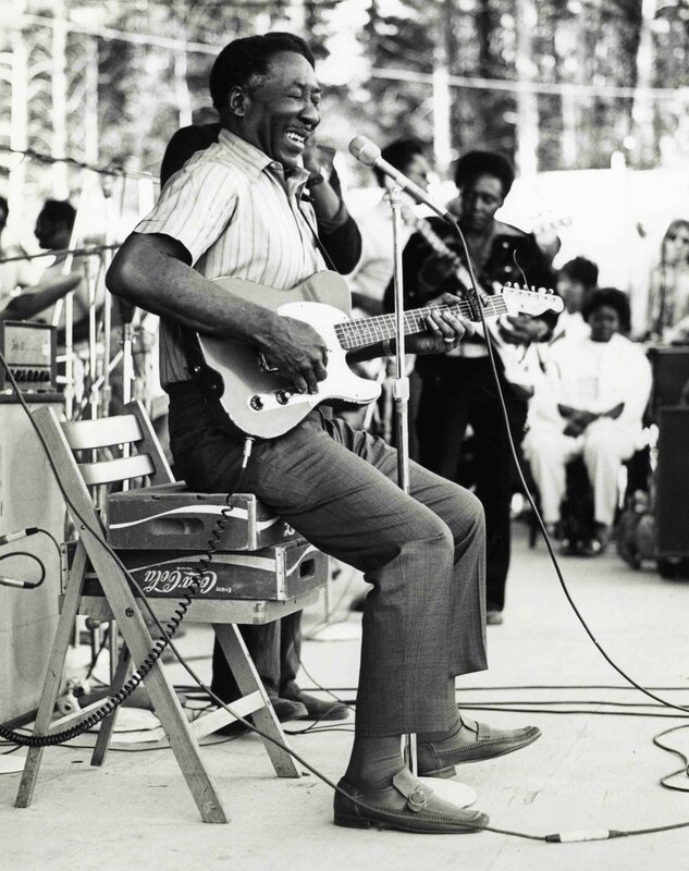 Musician playing guitar on stage