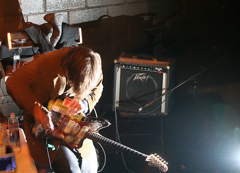 Musician playing guitar on stage