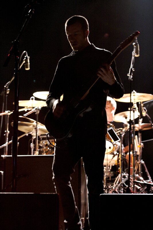 Musician playing guitar on stage