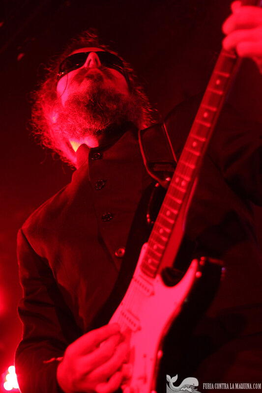 musician playing guitar on stage