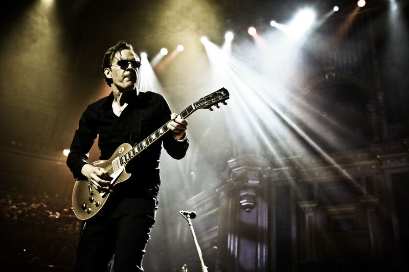 Musician playing guitar on stage
