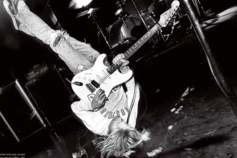 Musician playing guitar on stage