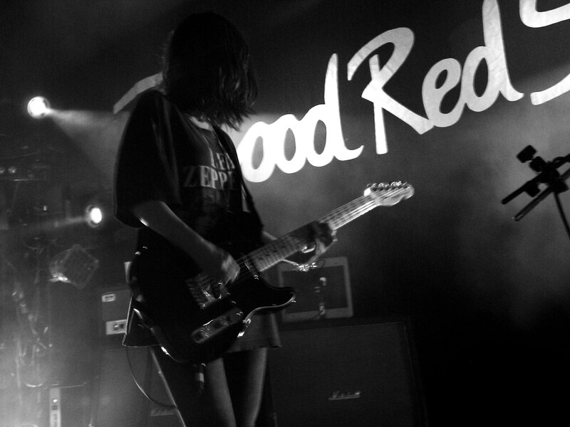 Musician playing guitar on stage