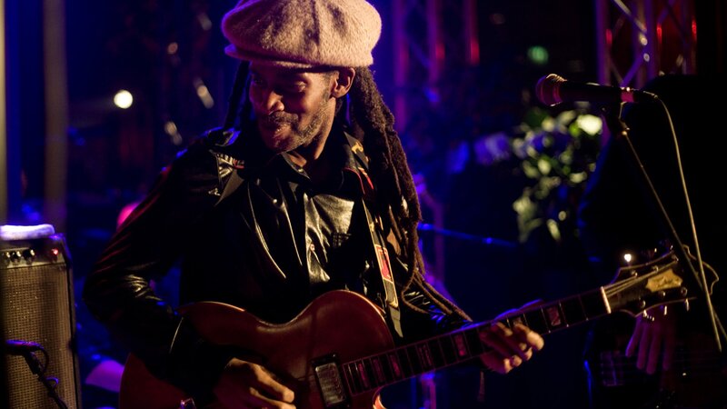 Musician playing guitar on stage