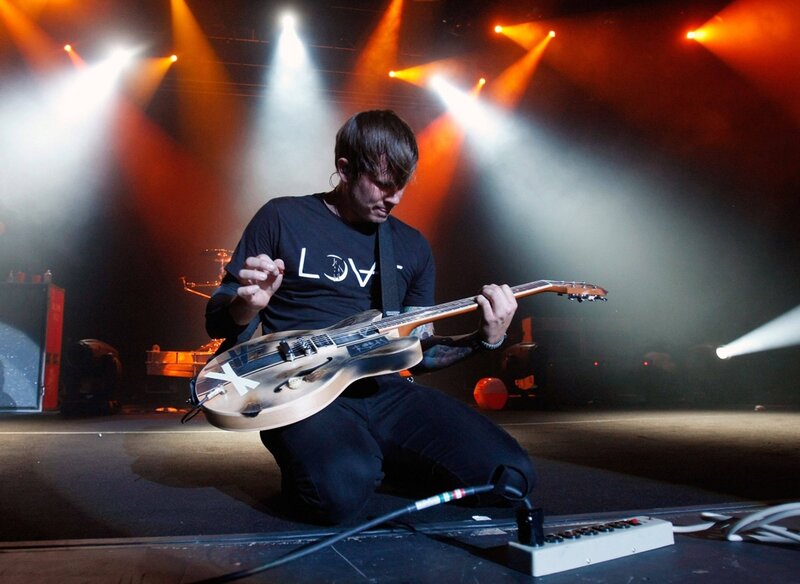 Musician playing guitar on stage