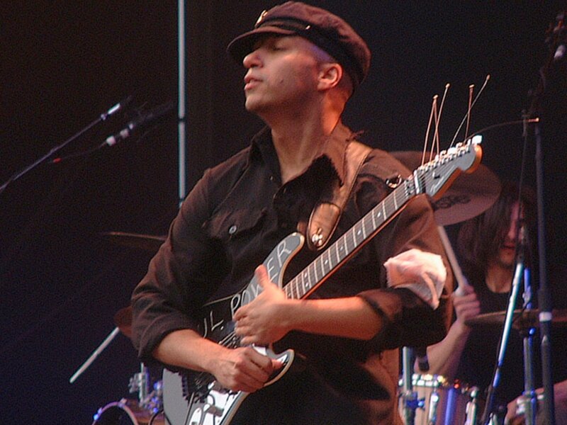 Musician playing guitar on stage