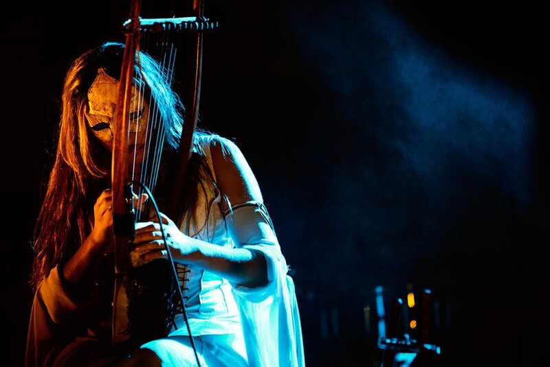 Musician playing harp on stage
