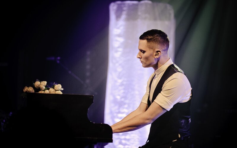 Musician playing piano on stage