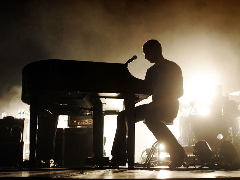 musician playing piano on stage