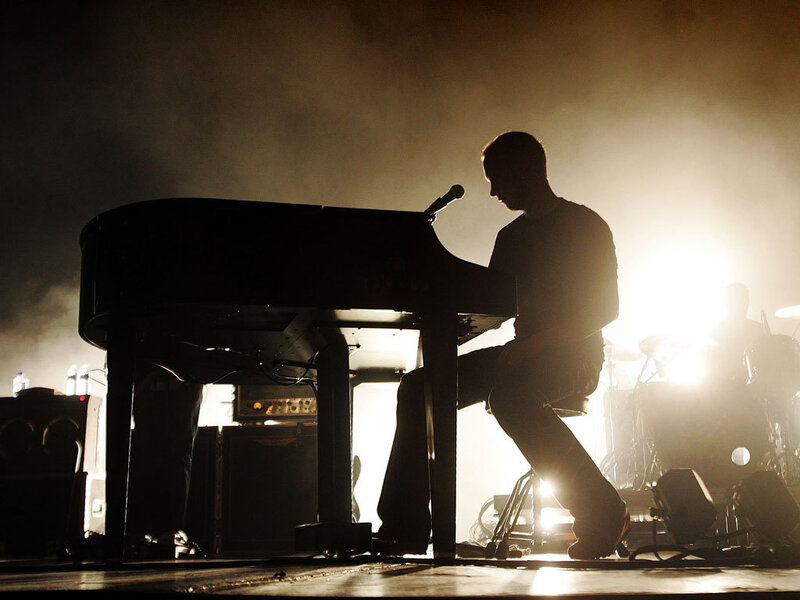 Musician playing piano on stage