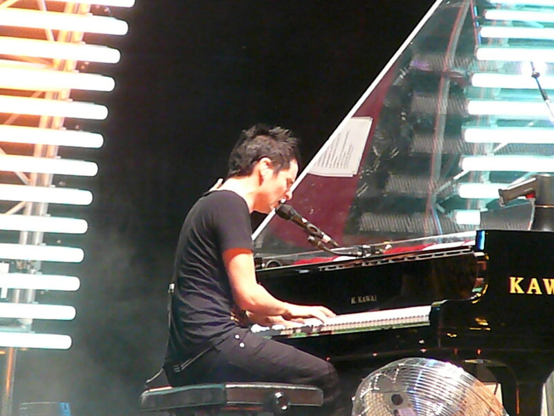 musician playing piano on stage