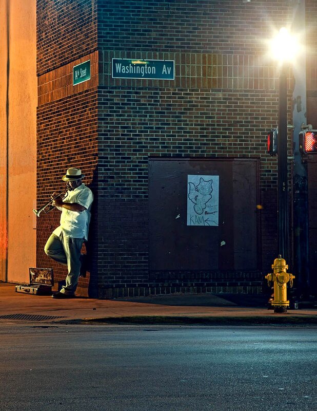 Musician playing trumpet at night