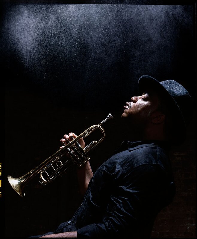Musician playing trumpet in dark