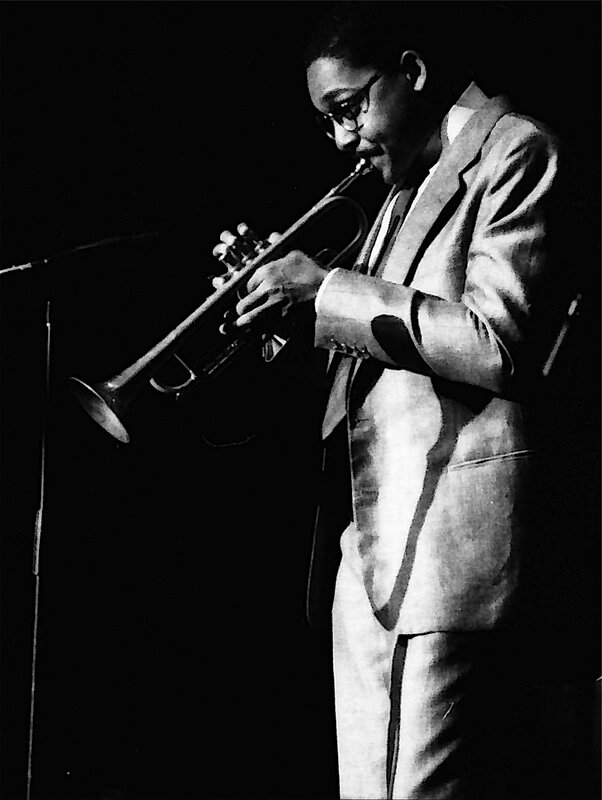 musician playing trumpet on stage