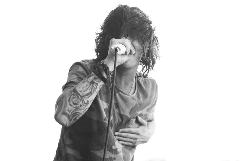 musician singing into microphone