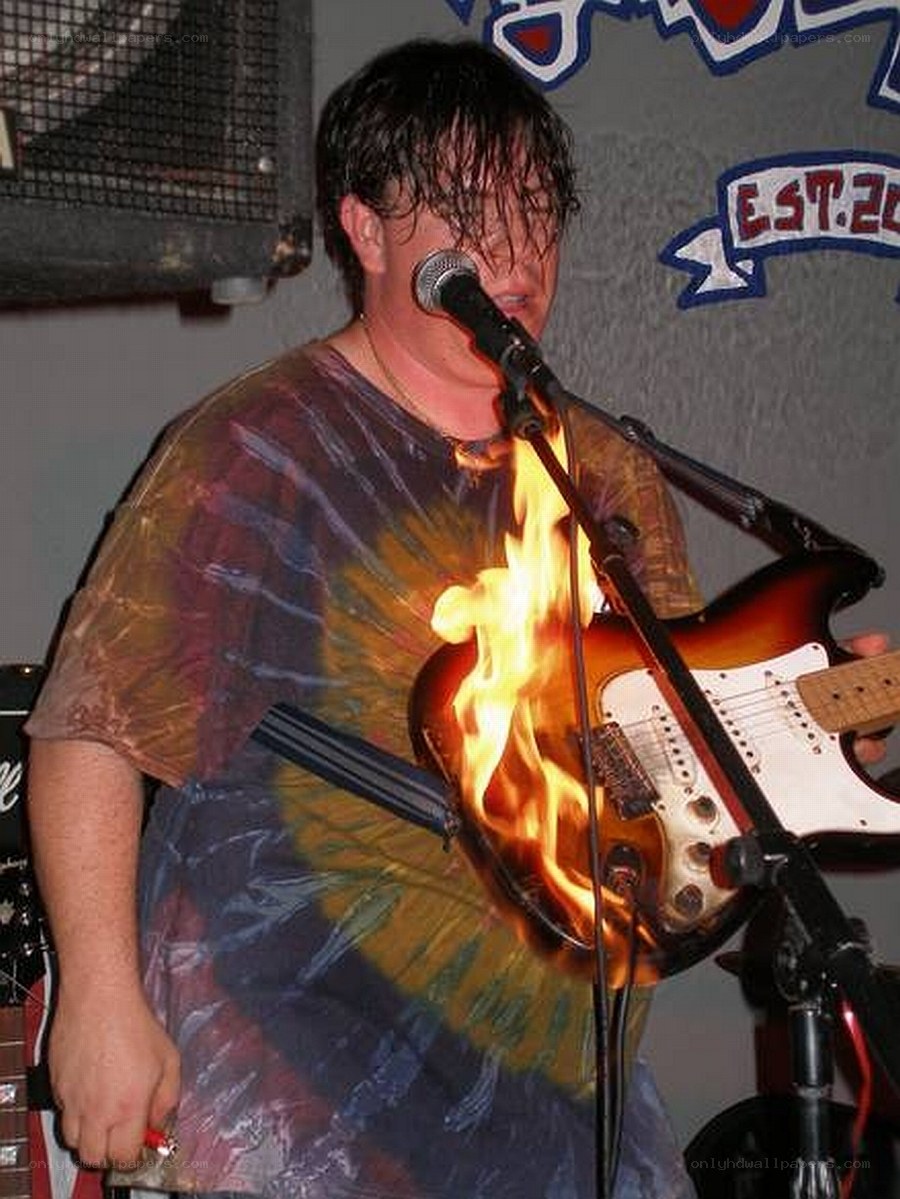 Musician with burning guitar