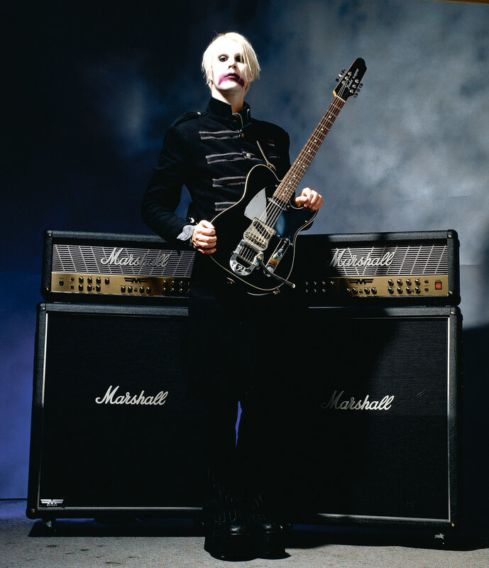 Musician with guitar and amplifiers