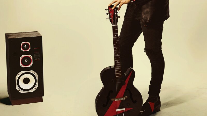 Musician with guitar and speaker