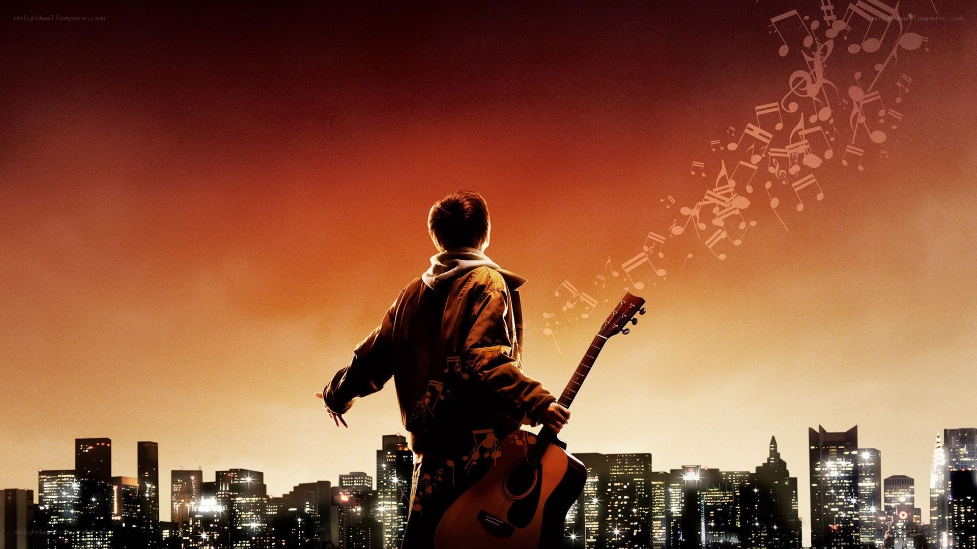 Musician with guitar at sunset