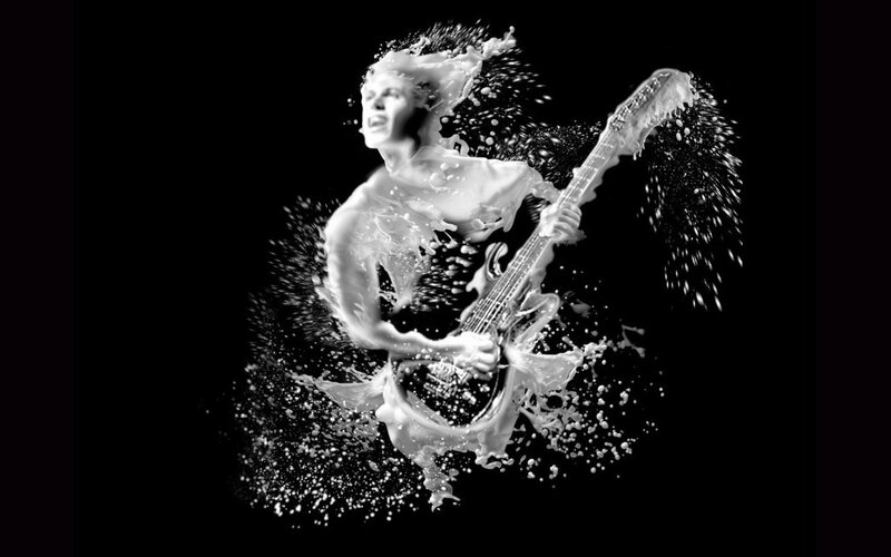 musician with guitar in milk splash