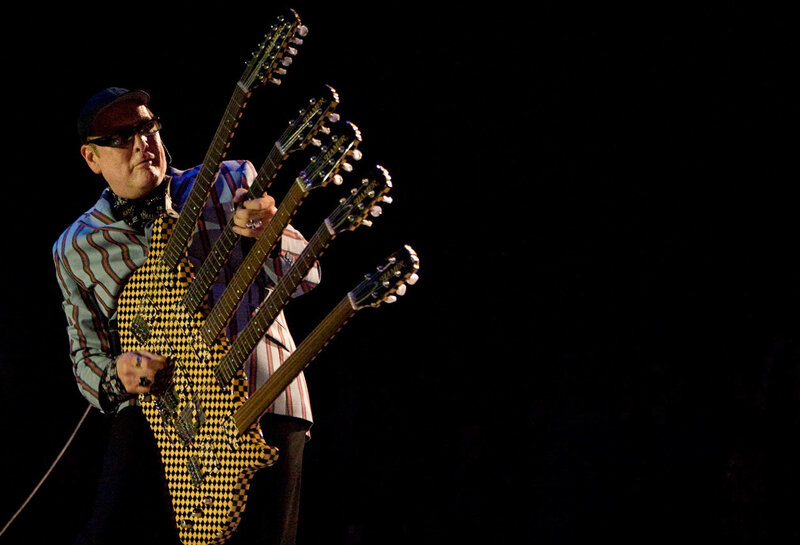 Musician with multi-neck guitar
