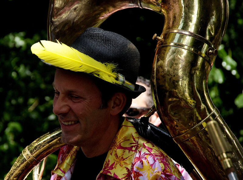 Musician with tuba and feather hat
