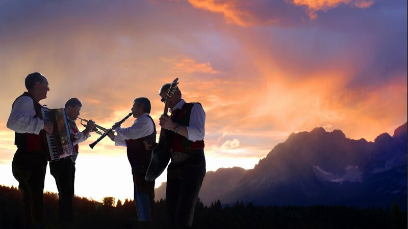 Musicians at sunset in the mountains