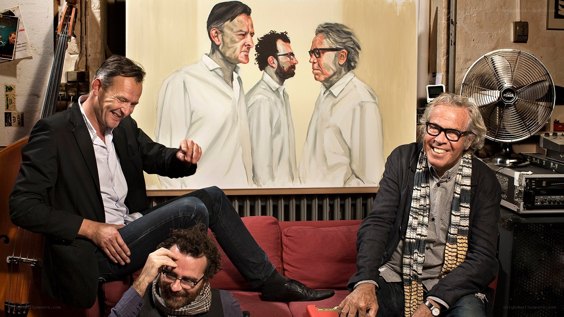 Musicians in a studio with a painting