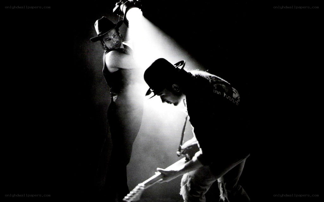 Musicians on stage under spotlight