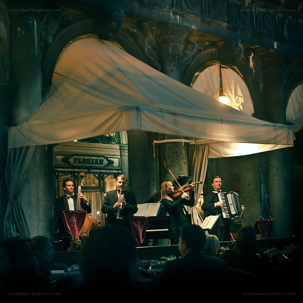 Musicians performing in a historic arcade